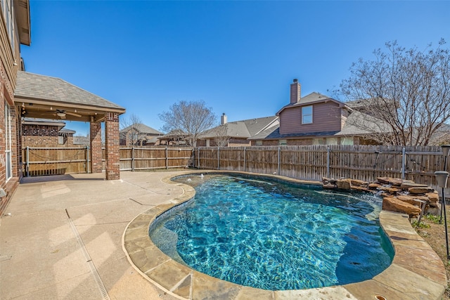 view of swimming pool with a fenced backyard, a fenced in pool, a ceiling fan, and a patio