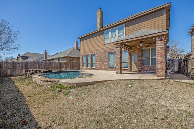 back of house featuring a fenced backyard, a patio, brick siding, and ceiling fan