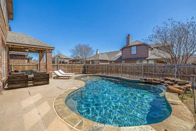 view of pool featuring a fenced in pool, a ceiling fan, a fenced backyard, outdoor lounge area, and a patio area