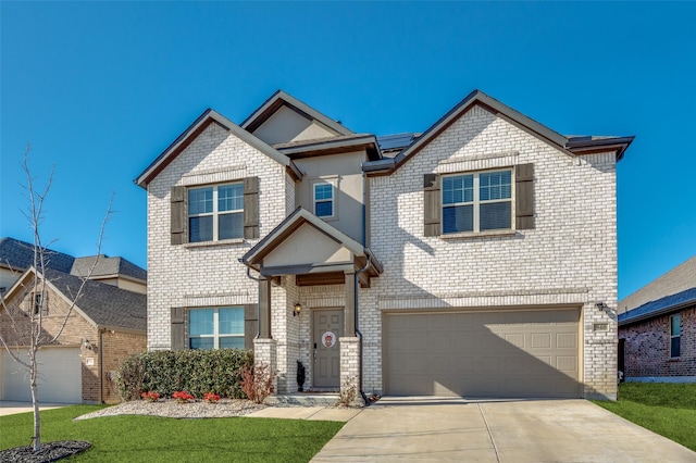 craftsman-style house featuring brick siding, an attached garage, and concrete driveway