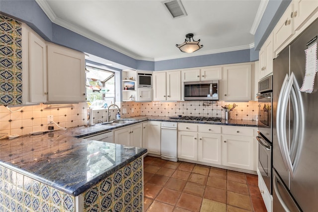 kitchen featuring ornamental molding, decorative backsplash, appliances with stainless steel finishes, a peninsula, and a sink