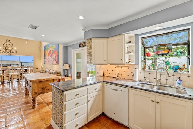 kitchen with crown molding, dishwasher, decorative backsplash, a peninsula, and a sink