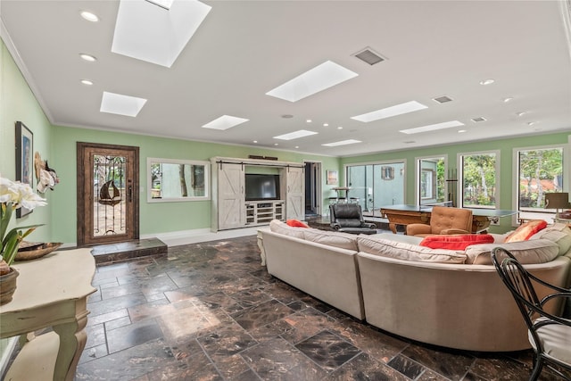 living room featuring stone tile floors, visible vents, recessed lighting, and baseboards