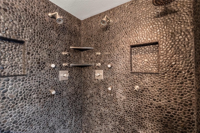 details featuring a tile shower and a textured ceiling