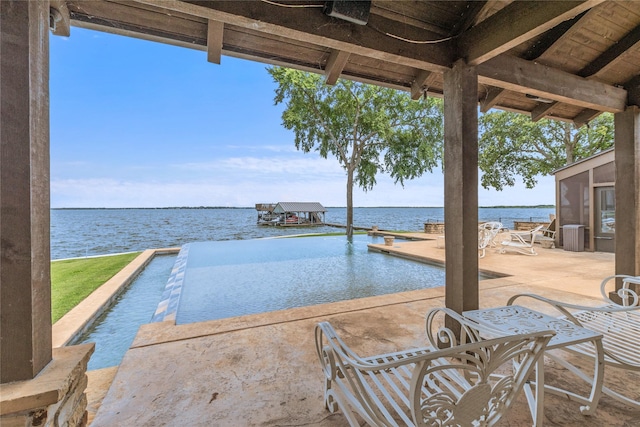 view of pool featuring a patio and a water view