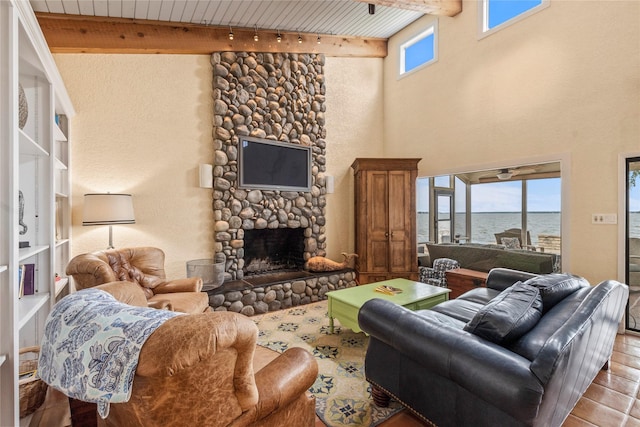 living area with beamed ceiling, a fireplace, wood ceiling, and wood finished floors