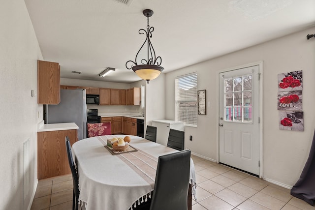 dining space with light tile patterned flooring and baseboards