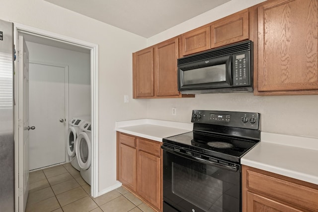 kitchen with black appliances, light tile patterned flooring, separate washer and dryer, and light countertops