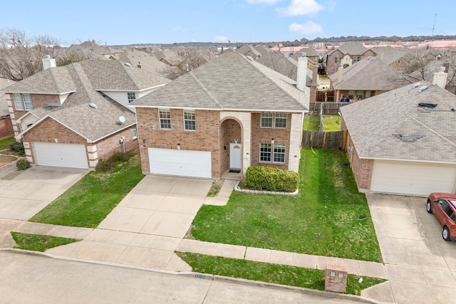 view of front facade with a front lawn, fence, brick siding, and a residential view