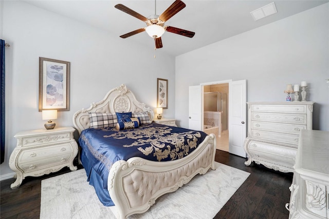 bedroom featuring visible vents, connected bathroom, a ceiling fan, and wood finished floors