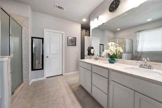 bathroom featuring a sink, visible vents, and a stall shower