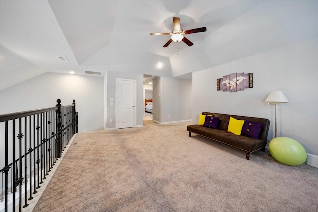 living area featuring visible vents, light colored carpet, ceiling fan, and vaulted ceiling