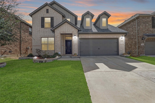 traditional-style home with a front yard, brick siding, a garage, and driveway