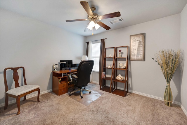 office space featuring carpet flooring, baseboards, visible vents, and ceiling fan