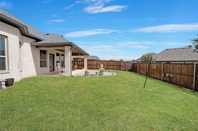 view of yard with a fenced backyard and a patio