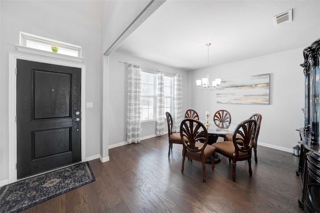 dining space with visible vents, baseboards, a notable chandelier, and dark wood finished floors