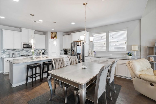 dining space with recessed lighting, visible vents, and dark wood-type flooring