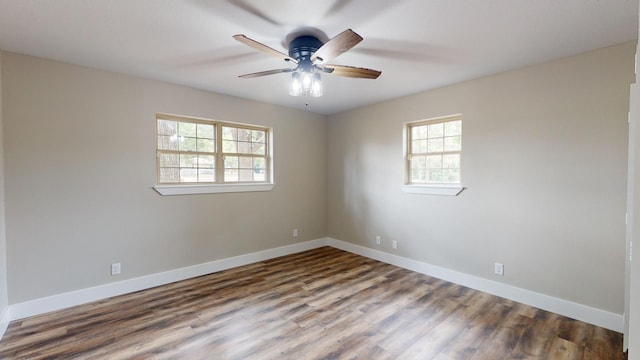 spare room featuring a ceiling fan, baseboards, and wood finished floors