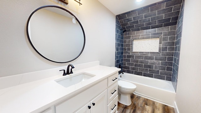 bathroom featuring shower / bathtub combination, toilet, vanity, and wood finished floors