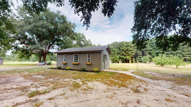 view of home's exterior with an outbuilding