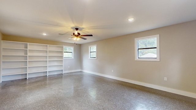 spare room featuring recessed lighting, baseboards, ceiling fan, and dark speckled floor