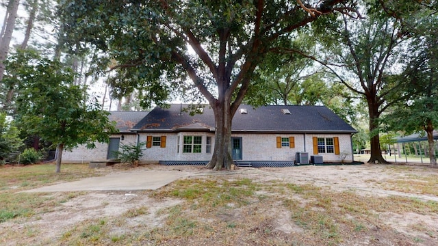 back of property featuring central air condition unit and a patio