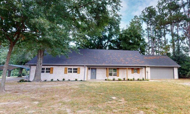 single story home with a garage and a front lawn