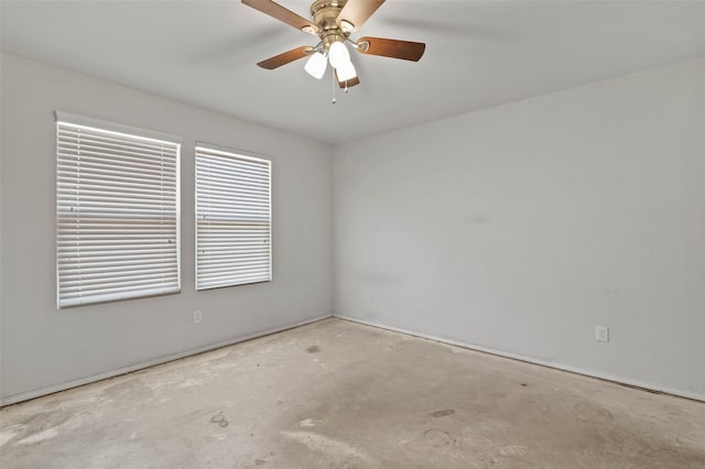 spare room featuring unfinished concrete flooring and ceiling fan