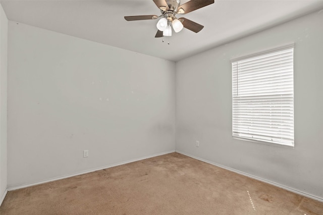 unfurnished room with baseboards, a ceiling fan, and carpet