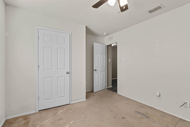 unfurnished bedroom featuring visible vents, carpet floors, and baseboards