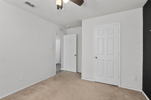 unfurnished bedroom featuring visible vents, baseboards, and carpet flooring