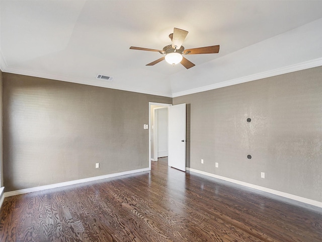 empty room with visible vents, ceiling fan, baseboards, ornamental molding, and wood finished floors