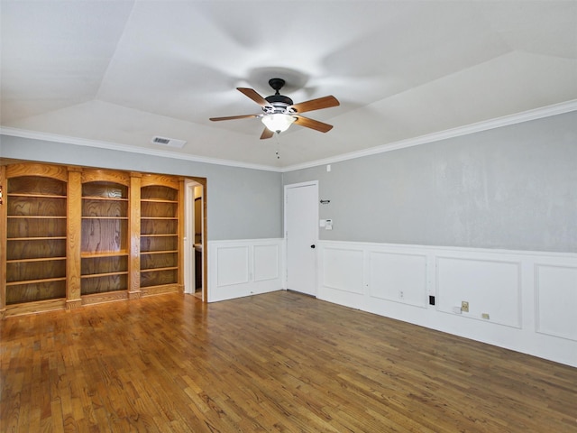 unfurnished living room featuring a ceiling fan, wood finished floors, visible vents, and ornamental molding