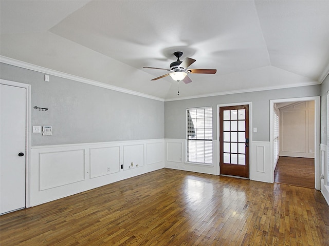 unfurnished room with a wainscoted wall, wood-type flooring, a ceiling fan, and crown molding