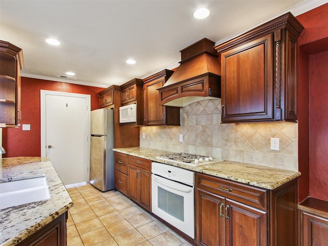 kitchen featuring white appliances, premium range hood, open shelves, a sink, and tasteful backsplash