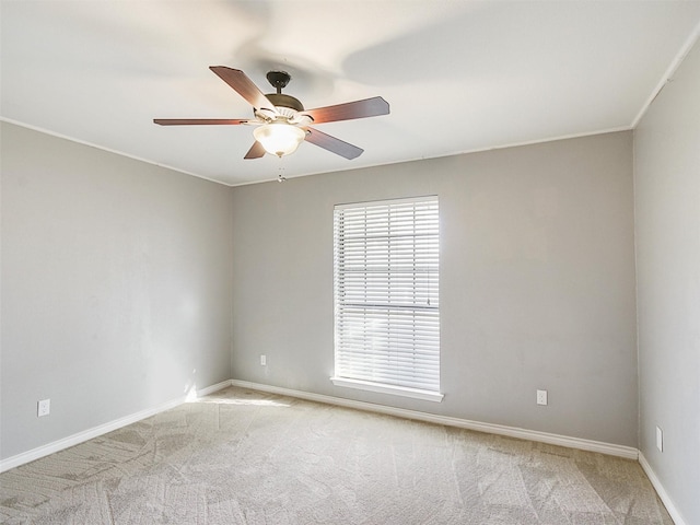 spare room featuring baseboards, carpet, and a ceiling fan