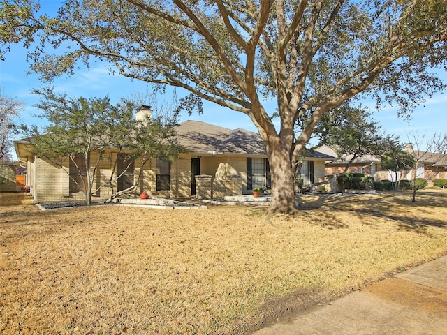 back of property featuring brick siding and a chimney