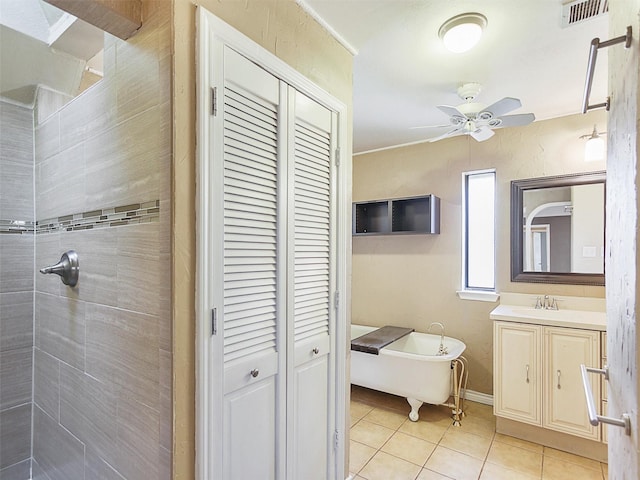 full bath with visible vents, a closet, tile patterned flooring, tiled shower, and vanity