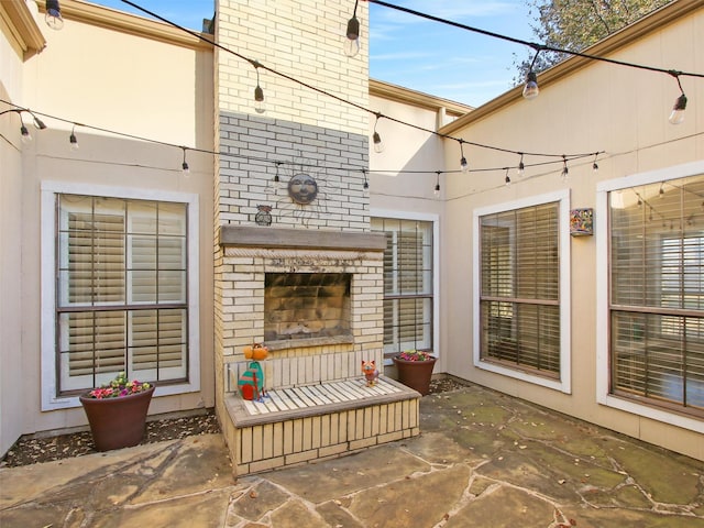 view of patio with an outdoor brick fireplace