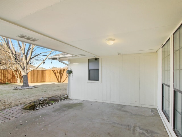 view of patio with visible vents and fence