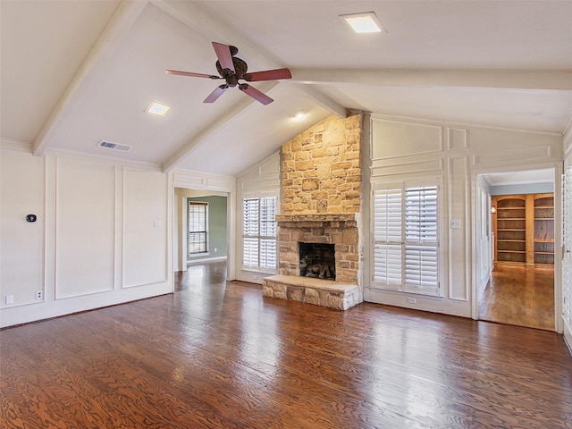 unfurnished living room featuring a decorative wall, a fireplace, and visible vents