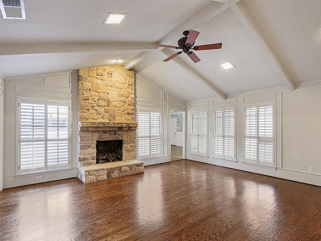 unfurnished living room featuring visible vents, vaulted ceiling with beams, wood finished floors, and a fireplace