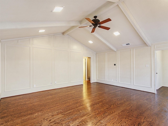 interior space featuring visible vents, vaulted ceiling with beams, a decorative wall, a ceiling fan, and dark wood-style flooring