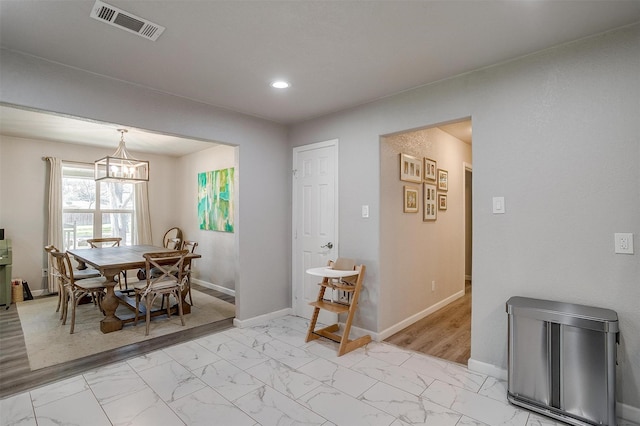 dining room featuring baseboards, visible vents, recessed lighting, marble finish floor, and a chandelier