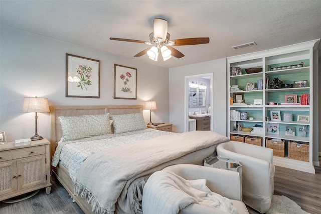 bedroom featuring visible vents, a ceiling fan, wood finished floors, and ensuite bathroom