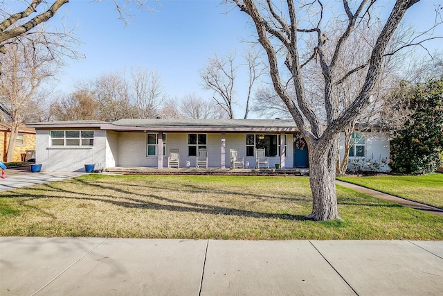 view of front of house featuring brick siding, a porch, and a front lawn