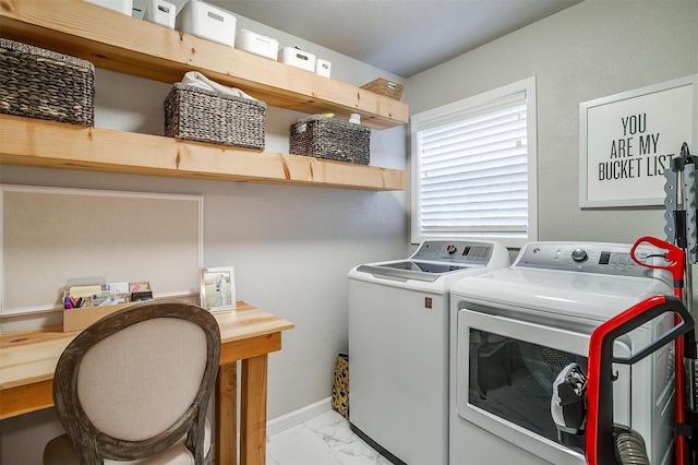 washroom with laundry area, marble finish floor, baseboards, and separate washer and dryer