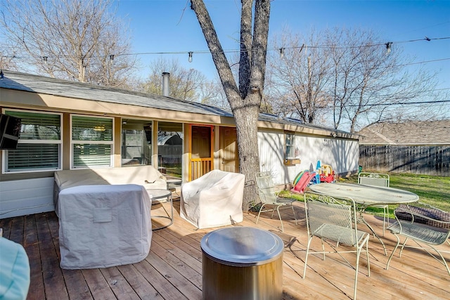 wooden deck with outdoor dining area and fence