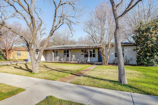 single story home with a porch and a front lawn