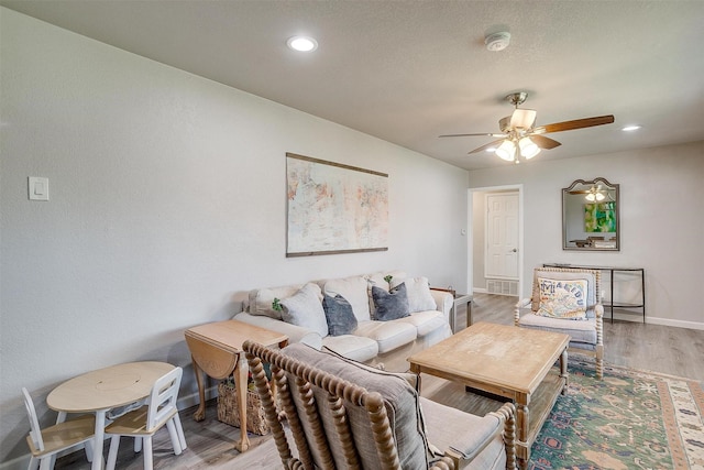 living area with recessed lighting, baseboards, light wood finished floors, and ceiling fan